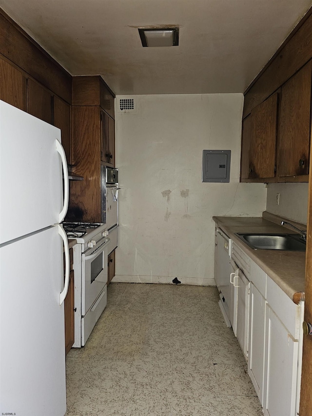 kitchen featuring sink, white appliances, electric panel, and dark brown cabinetry