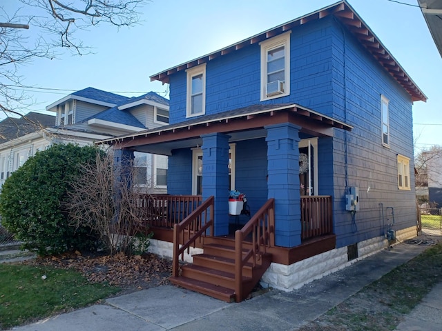 view of front of house featuring covered porch and cooling unit