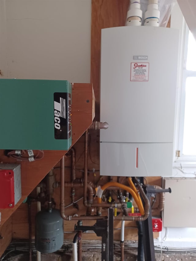 utility room featuring water heater