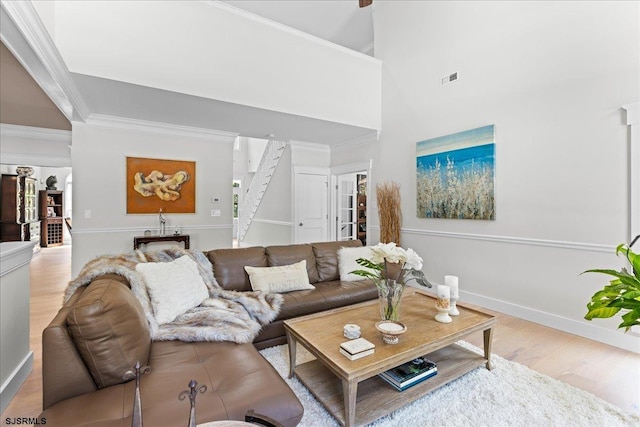 living room featuring light hardwood / wood-style flooring and crown molding