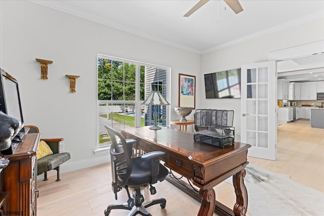 office area featuring a wealth of natural light, crown molding, ceiling fan, and light hardwood / wood-style floors