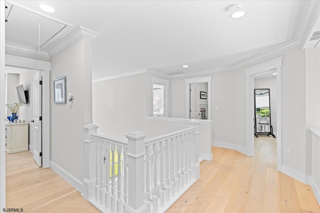 corridor with light hardwood / wood-style flooring and crown molding