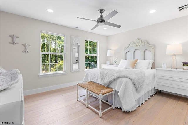 bedroom with ceiling fan and light hardwood / wood-style floors