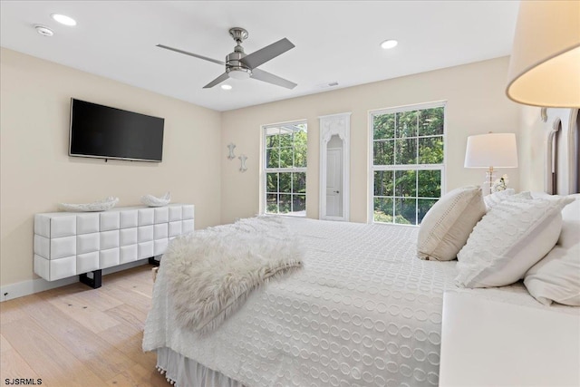 bedroom featuring ceiling fan and light hardwood / wood-style floors