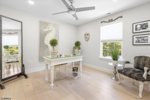 home office with ceiling fan and light wood-type flooring