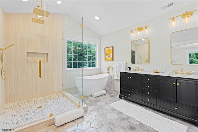 bathroom with tile patterned floors, dual bowl vanity, and separate shower and tub