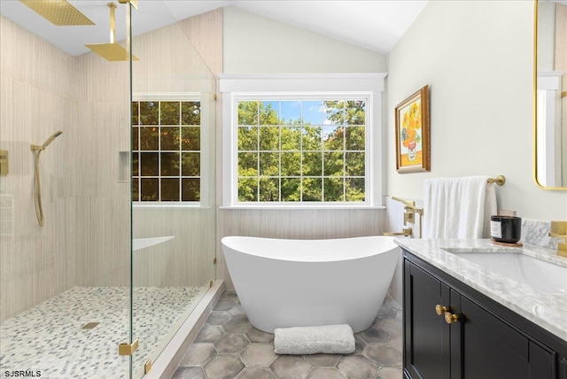 bathroom featuring tile patterned floors, vanity, vaulted ceiling, and a shower with shower door