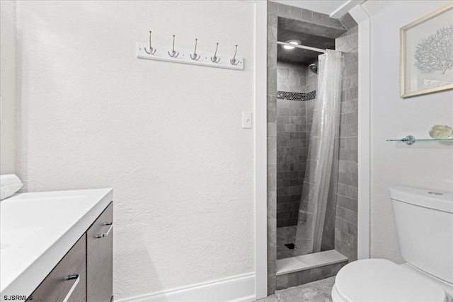 bathroom with vanity, a shower with shower curtain, and toilet