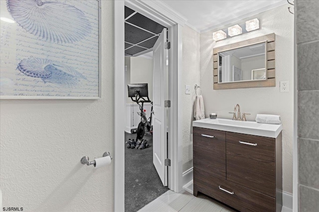 bathroom featuring crown molding, vanity, and tile patterned flooring