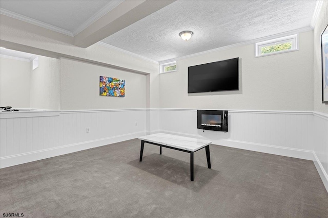 living area featuring beam ceiling, a textured ceiling, and carpet