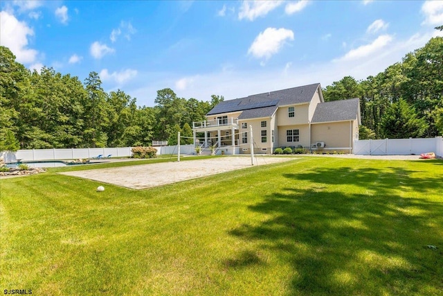 view of front of home with a front lawn and a fenced in pool