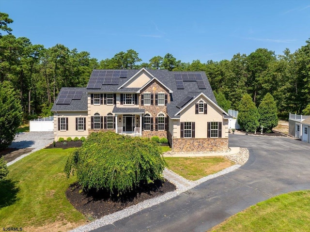 view of front of property featuring solar panels