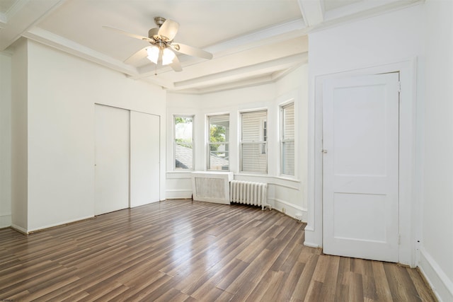 unfurnished bedroom with radiator, dark wood-type flooring, ceiling fan, a closet, and beamed ceiling