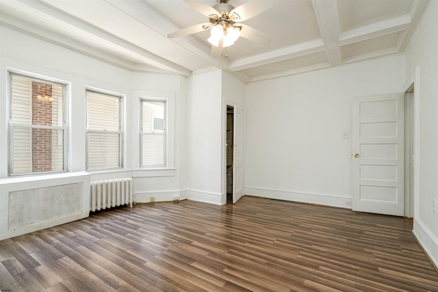 spare room featuring ceiling fan, radiator heating unit, dark hardwood / wood-style flooring, and beam ceiling