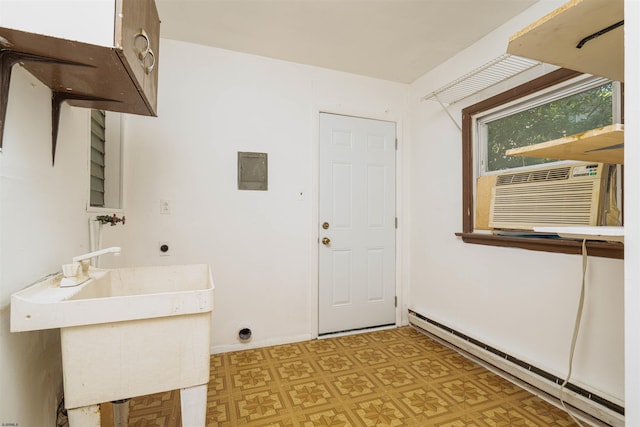 washroom featuring electric dryer hookup, a baseboard heating unit, sink, and cooling unit