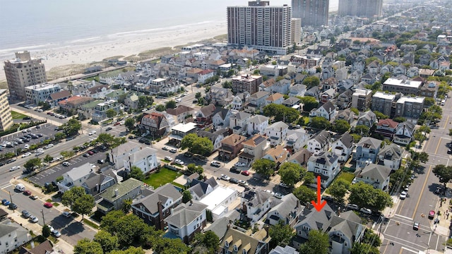 drone / aerial view with a water view and a view of the beach