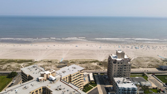 drone / aerial view with a water view and a beach view