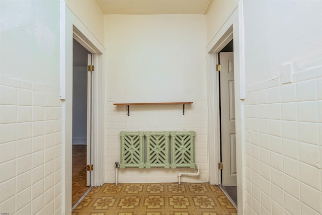 hallway featuring tile walls