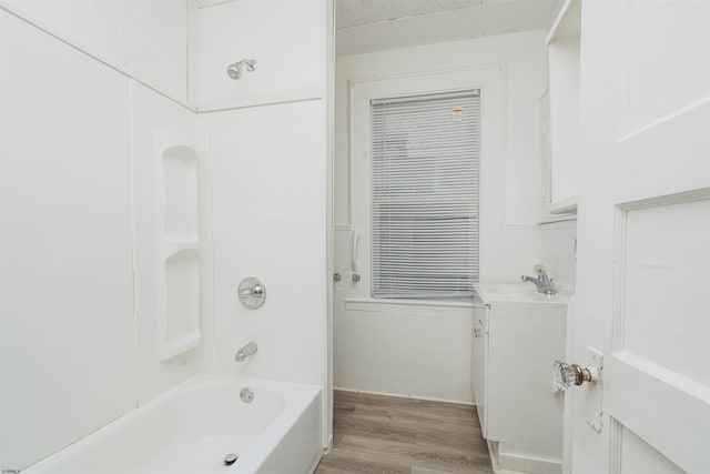 bathroom with wood-type flooring, tub / shower combination, and vanity