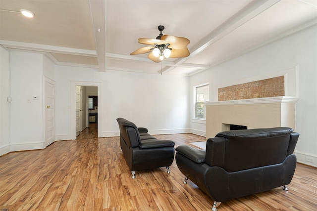 living room featuring beamed ceiling, coffered ceiling, and light wood-type flooring