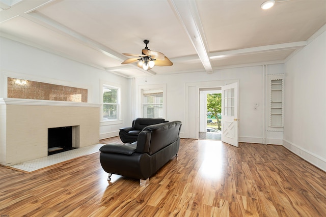 living room featuring beamed ceiling, wood-type flooring, and ceiling fan