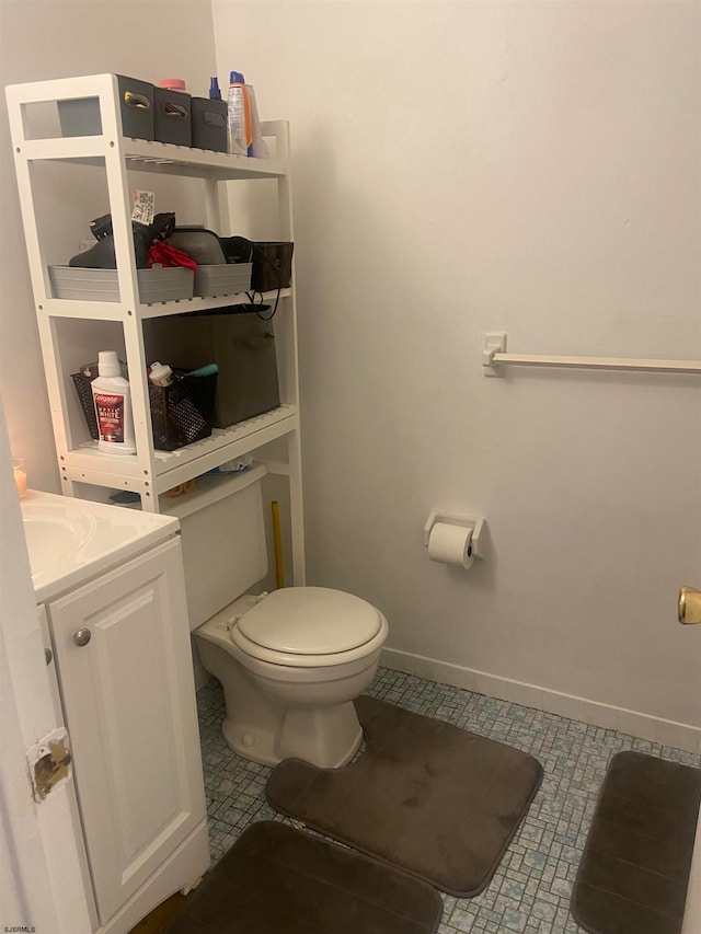 bathroom with tile patterned flooring, toilet, and vanity