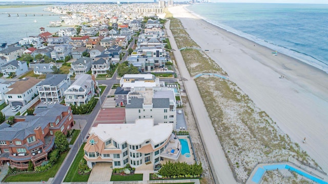 birds eye view of property featuring a water view and a view of the beach