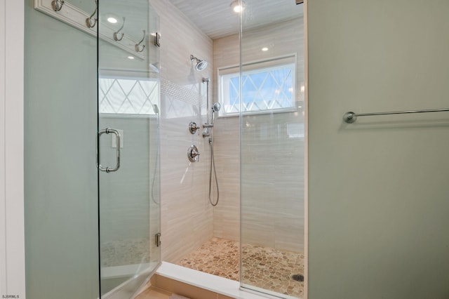 bathroom with a shower with door