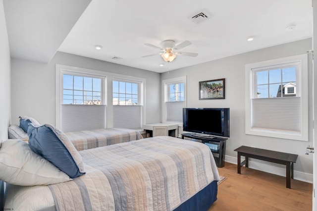 bedroom with ceiling fan and light hardwood / wood-style floors