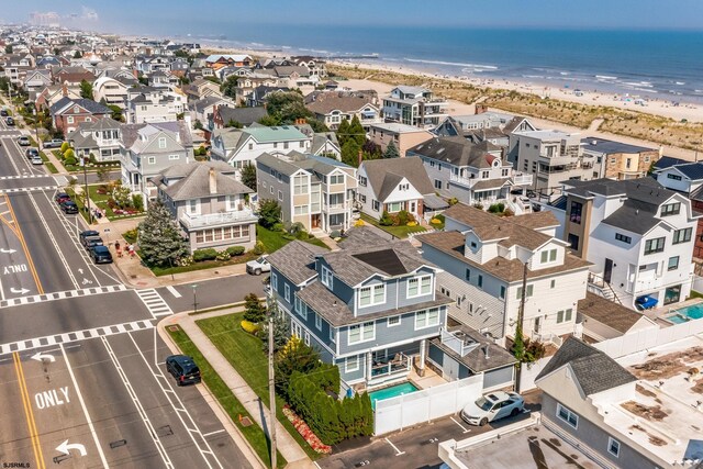 birds eye view of property featuring a water view and a view of the beach