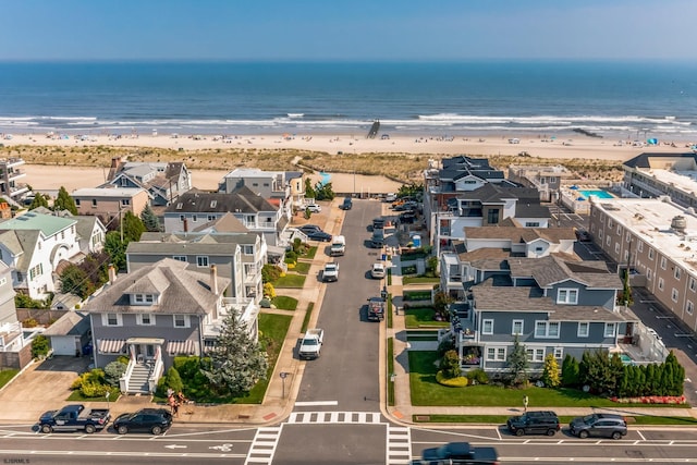 drone / aerial view with a water view and a view of the beach