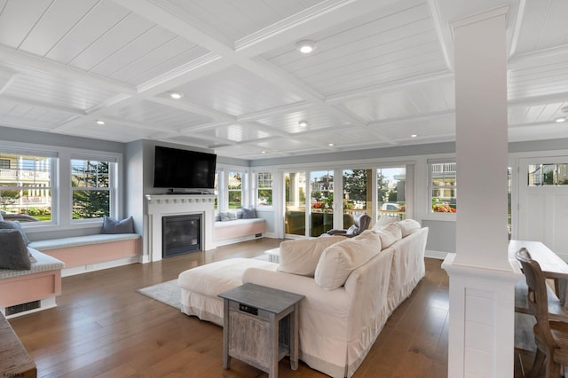 living room featuring coffered ceiling and a wealth of natural light