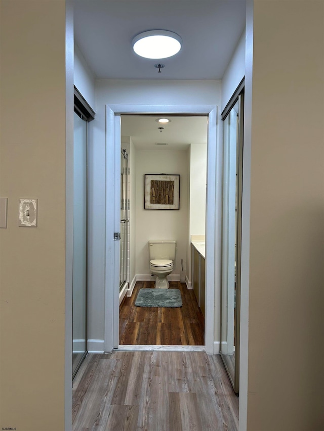 corridor featuring wood-type flooring