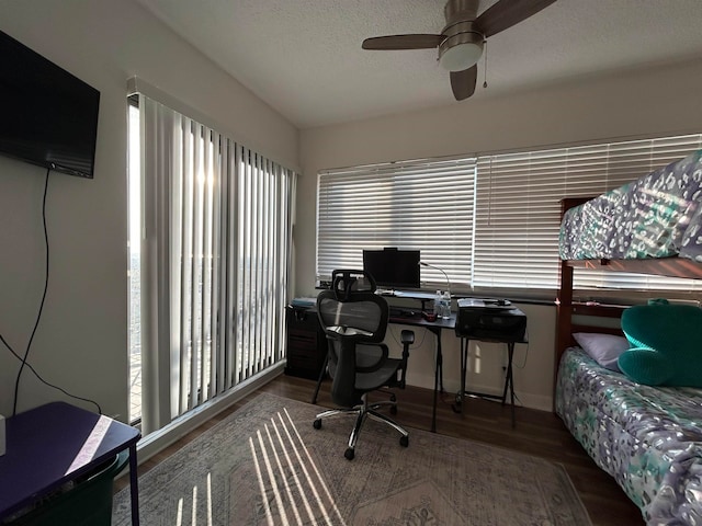 home office featuring ceiling fan, wood-type flooring, and a textured ceiling