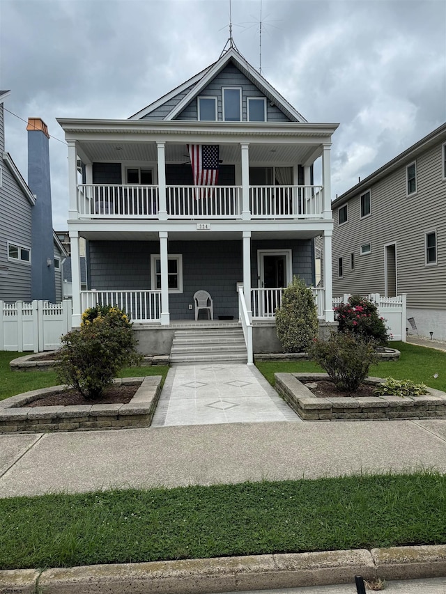 view of front of property with a balcony and a porch