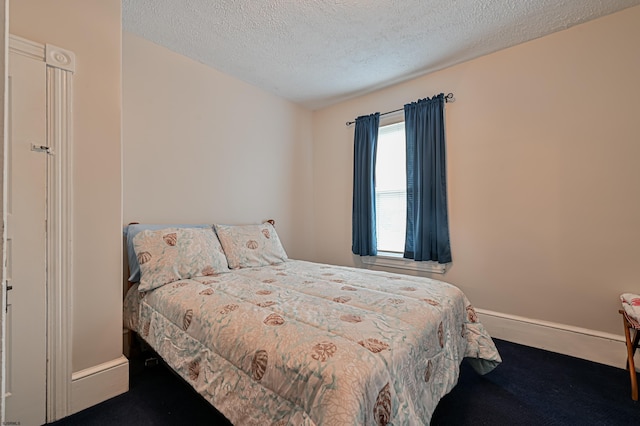 carpeted bedroom featuring a textured ceiling