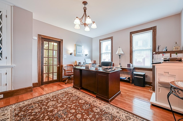 office with a notable chandelier and light hardwood / wood-style floors