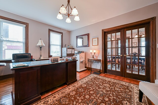 office area with light hardwood / wood-style flooring, french doors, and plenty of natural light