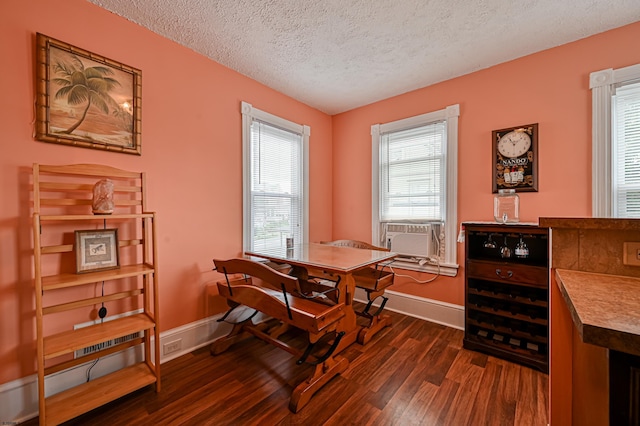 dining room featuring a textured ceiling, dark hardwood / wood-style floors, and cooling unit