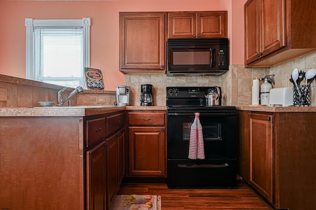 kitchen featuring black appliances, tasteful backsplash, and dark hardwood / wood-style floors