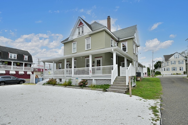 view of front of house featuring covered porch and a garage