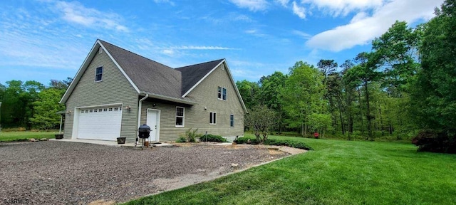 view of side of property featuring driveway and a yard