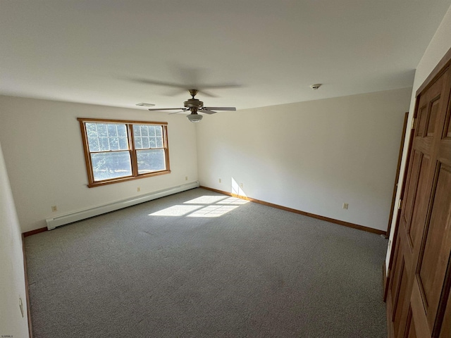 carpeted empty room with visible vents, ceiling fan, a baseboard heating unit, and baseboards