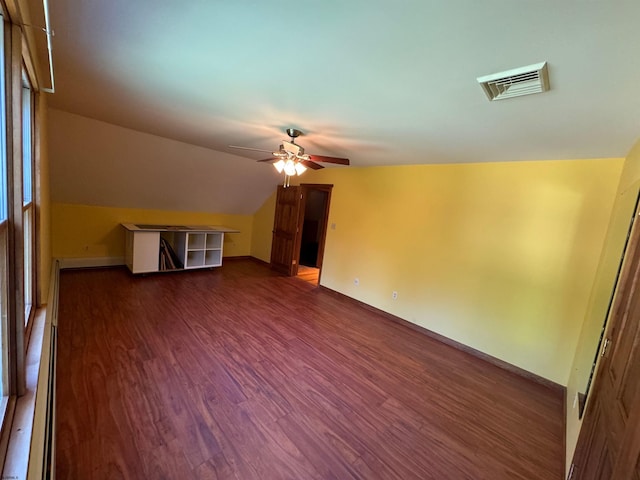 bonus room with visible vents, baseboards, vaulted ceiling, a ceiling fan, and dark wood-style flooring