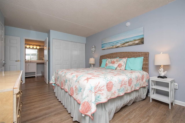 bedroom featuring wood-type flooring, a closet, and a textured ceiling