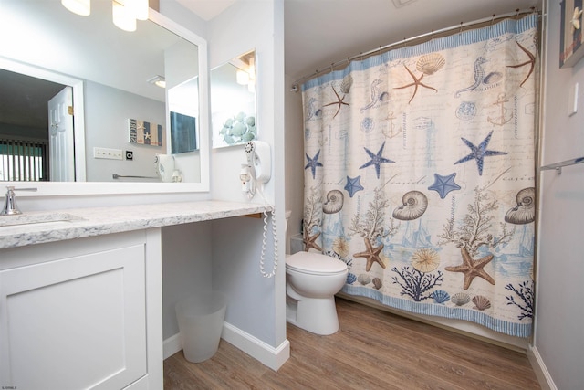 bathroom featuring vanity, hardwood / wood-style flooring, toilet, and a shower with shower curtain