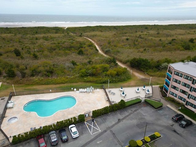 aerial view with a water view and a view of the beach