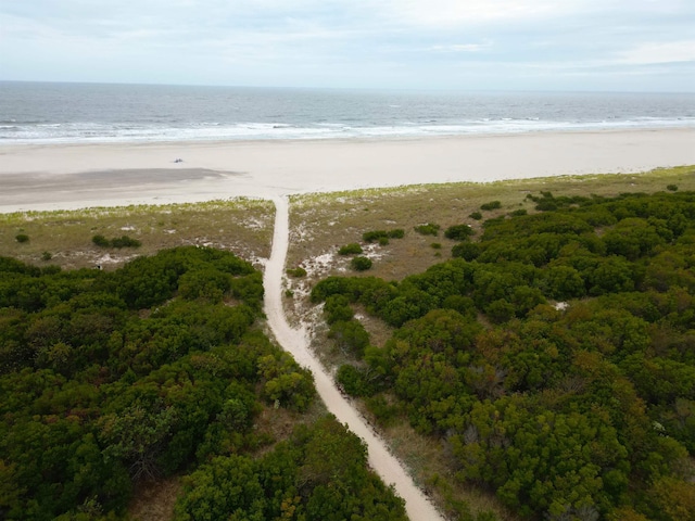 birds eye view of property with a view of the beach and a water view