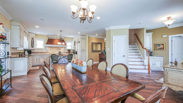 dining space with dark hardwood / wood-style flooring, ornamental molding, and a chandelier