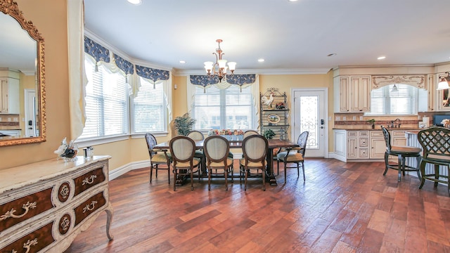 dining room with a notable chandelier, ornamental molding, dark hardwood / wood-style flooring, and a healthy amount of sunlight